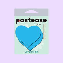 Load image into Gallery viewer, Packaging of Pastease® Love Glow in the Dark Neon Turquoise Heart Pasties. A mint green box features bold branding, a pair of blue heart-shaped nipple covers, and the tagline "You Glow Girl." Pastease® is a small, family-run USA business creating unique nipple covers for all breast shapes and sizes, perfect for fun or flirty occasions.
