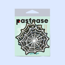 Load image into Gallery viewer, Packaging for Web: Glitter Black Glow in the Dark Spooky Spider Web Nipple Covers by Pastease®. Features a pair of glittery black and white spiderweb-shaped nipple covers on a mint green backing card with 'Pastease' branding. Designed for all breast shapes and sizes, handmade in the USA.