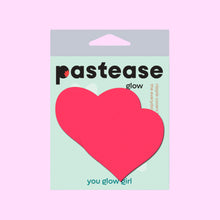 Load image into Gallery viewer, Pastease Glow heart-shaped nipple covers in neon pink, shown in their light mint green packaging with “You Glow Girl” printed at the bottom. Made in the USA by a small family business, these nipple covers are perfect for festivals, boudoir shoots, or everyday confidence.
