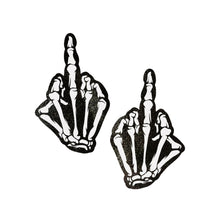 Load image into Gallery viewer, Close-up of black and white glow-in-the-dark Middle Finger Skeleton Hand Pasties by Pastease. Designed for all breast sizes, these unique nipple covers add playful gothic vibes to your style, handcrafted in the USA by a family-operated brand.