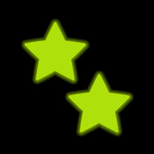 Load image into Gallery viewer, Star Neon Yellow Pasties Glow in the Dark Star Nipple Covers by Pastease® glowing brightly in a dark setting. The neon yellow stars emit a bold, fun light, making them ideal for night-time events, parties, or festivals.