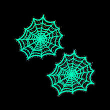 Load image into Gallery viewer, Web: Glitter Black Glow in the Dark Spooky Spider Web Nipple Covers by Pastease®. Set against a black background, the glowing green spiderweb nipple covers shine vividly. Handmade in the USA, perfect for costume parties or sultry nights in.