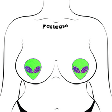 Load image into Gallery viewer, Alien: Neon Green/Glow in the Dark with Glittering Black Eyes Nipple Pasties by Pastease®. Two green extraterrestrial heads with glitter eyes nipple covers shown on a femme body outline for size reference on a white background.