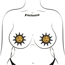 Load image into Gallery viewer, Sunburst: Sun & Moon Faces on Gold Glitter Sun Nipple Pasties by Pastease®. Two glittery gold and black nipple covers in the shape of a sun and moon, shown on drawing of chest. Perfect for a festival, burlesque performance, pride or parties.