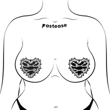 Load image into Gallery viewer, The Barbed Wire Heart Pasties Reflective Nipple Covers by Pastease®. Two black hearts with silver reflective barbed wire patterned shaped nipple covers shown on a femme body outline for size reference on a white background. Perfect for festivals, pride, burlesque, raves, only fans content or parties.
