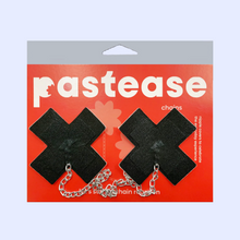 Load image into Gallery viewer, The Chains: Liquid Black Plus X Cross with Chunky Silver Chain Nipple Pasties by Pastease®. Two shiny black cross plus X shaped nipple covers with a chunky silver chain connecting them together shown in the red pastease packaging on a pastel lilac background. Perfect for a festival, pride, burlesque or party.