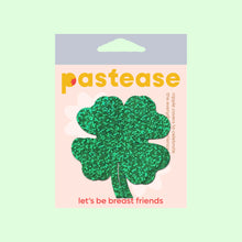 Load image into Gallery viewer, The Four Leaf Clover: Glittering Green Shamrocks Nipple Pasties by Pastease® in the pastease pastel cellophane packaging on a pastel green background. Two green glitter four leaf clover nipple covers. Perfect for a festival, burlesque performance, drag shows, pride or parties.