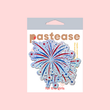 Load image into Gallery viewer, The Fireworks Pasties Star Explosion Glitter Nipple Covers by Pastease®. Two firework star explosion in blue, red and silver nipple covers in the pastease pastel packaging on pastel red background. Perfect for new years eve, a festival, burlesque performance, pride or parties.