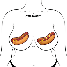 Load image into Gallery viewer, The Hotdog Pasties Weiner with Mustard Nipple Covers by Pastease®. Two hot dog sausages in long buns with mustard drizzled across in a zig zag pattern nipple covers shown on a femme body outline on a white background. Perfect for a festival, burlesque performance, drag shows, pride or parties.