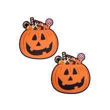 Load image into Gallery viewer, The Trick-or-Treat Pumpkin Pasties with Candy Nipple Covers by Pastease®. Two jack o lantern carved pumpkins stuffed full of various halloween candy nipple covers shown on a white background. Perfect for festivals, pride, burlesque, raves, only fans content or parties.