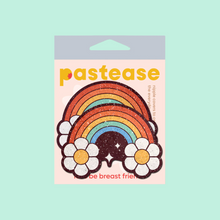 Load image into Gallery viewer, The Rainbow Flower Pasties Nipple Covers by Pastease®. Two glitter velvet retro warm rainbows with flower clouds and white sparkles nipple covers shown in the pastease pastel packaging on a pastel teal background. Perfect for a festival, burlesque performance, pride or parties.