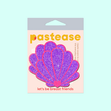 Load image into Gallery viewer, The Mermaid Shell Pasties in Neon Pink & Purple Glitter Seashell Nipple Covers by Pastease®. Two neon pink and purple glitter sea shells in pastel pastease packaging on a mint blue background. Perfect for a festival, pride, burlesque performance, only fans content or a party.