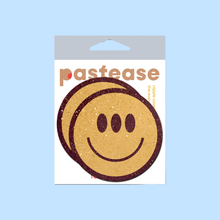 Load image into Gallery viewer, The Trippy Smiley Face Pasties Three Eyed Yellow Breast Covers by Pastease®. Two smiley faces with three eyes nipple covers shown in the pastease pastel packaging on a pastel blue background. Perfect for a festival, burlesque performance, pride or parties.