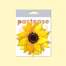 Load image into Gallery viewer, The Sunflower Pasties Nipple Covers by Pastease in the pastease cellophane packaging on a pastel yellow background. Two yellow sunflower shape nipple covers with brown middles and golden warm yellow petals surrounding. Perfect for burlesque shows, drag, content, pride, festivals and summer celebrations.
