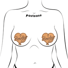 Load image into Gallery viewer, Howdy' Cowboy Rope Heart Lasso Pasties Nipple Covers by Pastease®. Two gold glittery lasso heart shaped nipple covers with 'Howdy' written in lasso shown on outline of feminine chest