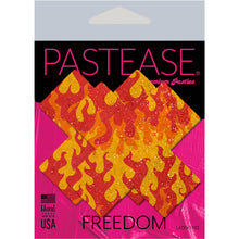 Load image into Gallery viewer, Plus X: Flaming Sparkle Cross Nipple Pasties by PasteaseĀ® o/s in the pastease pink and black packaging. Perfect for a festival, pride, burlesque performance, only fans content or a party.