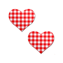Load image into Gallery viewer, Love: Red Gingham Heart by PasteaseĀ®. Two red gingham check pattern heart shaped nipple covers on a white background. Perfect for a festival, pride, burlesque performance, only fans content or a party.