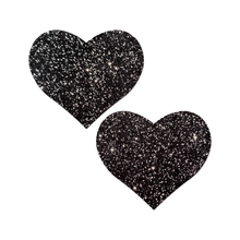 Load image into Gallery viewer, Love: Sparkle Velvet Heart Pasties by Pastease® o/s. Two glittery black heart shaped nipple covers on a white background. Perfect for a festival, pride, burlesque performance, only fans content or a party.