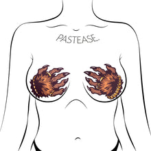 Load image into Gallery viewer, Monster Hands Pasties: Classy Werewolf Claws Nipple Covers by Pastease®. Two brown monster hands with long claws and gold jewellery in a clasped shape nipple covers shown on a femme body outline for size reference on a white background.