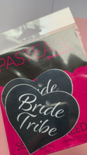 Load and play video in Gallery viewer, Video of the Love: Black 'Bride Tribe' Heart Nipple Pasties by Pastease in the pink and black Pastease packaging.