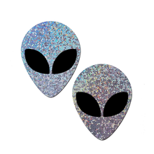 Load image into Gallery viewer, Alien: Silver Glitter Alien with Spacey Black Eyes Nipple Pasties by Pastease® o/s. Two silver holographic glitter alien nipple covers on a white background. Perfect for a festival, pride, burlesque performance, only fans content or a party.