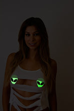 Load image into Gallery viewer, Alien: Neon/Green Glow in the Dark Alien Face by Pastease® o/s. Smiley long haired model wearing Two alien shaped nipple covers with glittery black eyes on white background. Perfect for a festival, pride, burlesque performance, only fans content or a party.