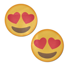Load image into Gallery viewer, Emoji: Yellow smiley face with heart eyes nipple pasties by pastease. Yellow circle smiling emojis with heart eyes on a plain white background. Perfect for a festival, pride, burlesque performance, only fans content or a party.