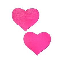 Load image into Gallery viewer, The Love: Neon Pink (Blacklight Reactive) Heart Nipple Pasties by Pastease. Two neon red heart nipple covers on a white background. Perfect for a festival, pride, burlesque performance, only fans content or a party.