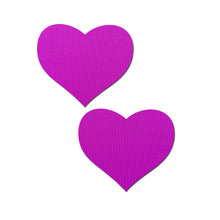 Load image into Gallery viewer, Love: Neon Purple (Blacklight Reactive) Heart Nipple Pasties by Pastease. Two bright neon purple uv heart shaped nipple covers shown on a white background. Perfect for a festival, pride, burlesque performance, only fans content or a party.