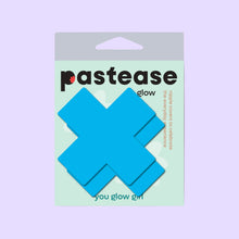 Load image into Gallery viewer, Packaging of Pastease Plus X Glow-in-the-Dark Neon Turquoise Cross Pasties, designed for all breast shapes and sizes. Bright turquoise X-shaped nipple covers are displayed in front of pastel packaging with &quot;You Glow Girl&quot; branding, made for fun and flirty self-expression.
