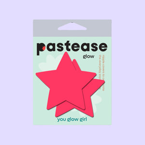 Packaging for Pastease® Neon Pink Glow in the Dark Star Nipple Covers. These vibrant star-shaped pasties are designed to celebrate all breast shapes and sizes, offering a flirty and fun accessory. Made in the USA, Pastease® is a family-operated brand distributing globally.