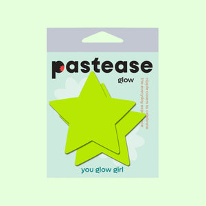 Packaging of Star Neon Yellow Pasties Glow in the Dark Star Nipple Covers by Pastease®, showing two bright yellow star-shaped pasties against a light background. The packaging includes the tagline "you glow girl." Perfect for all breast shapes and sizes, handmade in the USA.