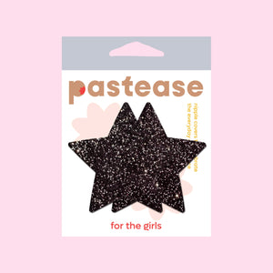 Pastease® Star Sparkle Black Star Nipple Pasties in original packaging. The packaging features a soft pink background with bold brown branding and the tagline "for the girls."