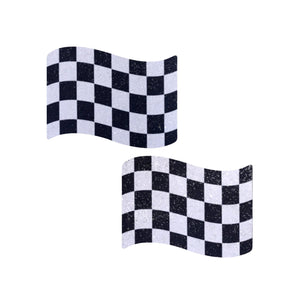 Close-up of Pastease Checkered Flag Racing Breast Pasties out of packaging, showcasing their glittery black and white chequered flag design. These USA-made nipple covers fit all shapes and sizes, offering playful, high-quality accessories for bold self-expression.