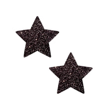 Load image into Gallery viewer, Close-up of Pastease® Star Sparkle Black Star Nipple Pasties. The pasties are shaped like five-pointed stars, covered in black glitter for a dazzling effect.
