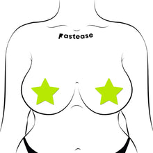 Load image into Gallery viewer, Illustration of Star Neon Yellow Pasties Glow in the Dark Star Nipple Covers by Pastease® worn on a fuller-busted model. The bright yellow stars stand out against the black and white artwork, highlighting their adaptability and glow-in-the-dark feature.
