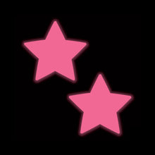 Load image into Gallery viewer, Neon Pink Glow in the Dark Star Nipple Covers by Pastease® glowing on a black background. These bold, flirty pasties are perfect for adding a statement to your style, handcrafted in the USA by a family-operated brand.
