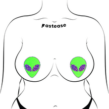 Load image into Gallery viewer, Alien: Neon Green/Glow in the Dark with Glittering Purple Eyes Nipple Pasties by Pastease®. Two green extraterrestrial heads with glitter eyes nipple covers shown on a femme body outline for size reference on a white background.
