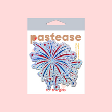 Load image into Gallery viewer, The Fireworks Pasties Star Explosion Glitter Nipple Covers by Pastease®. Two firework star explosion in blue, red and silver nipple covers in the pastease pastel packaging on pastel red background. Perfect for new years eve, a festival, burlesque performance, pride or parties.
