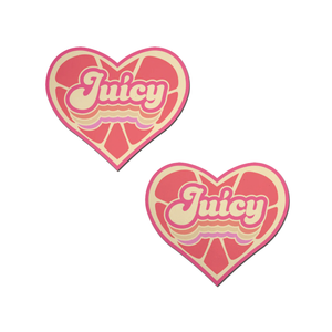 Love: 'Juicy' Pink Grapefruit Retro Heart Pasties Affirmations by Pastease®. Two pink heart shaped nipple covers with grapefruit pattern and 'Juicy" written in yellow, shown on white background. Perfect for a festival, burlesque performance, pride or parties.