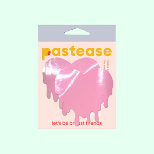 Melty Heart: Faux Latex Pleather Vinyl Baby Pink Melty Heart Nipple Pasties by Pastease®. Two shiny pastel pink drippy heart shaped nipple covers shown in the pastease packaging on a mint green background.