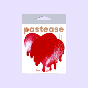 Melty Heart: Faux Latex Pleather Vinyl Red Melty Heart Nipple Pasties by Pastease®. Two shiny red drippy heart shaped nipple covers shown in the pastease packaging on a lilac background.