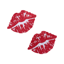 Load image into Gallery viewer, Kisses: Sparkly Red Kissing Puckered Lips Nipple Covers by Pastease. Two glitter red kissing lip shaped nipple covers shown on a white background. Perfect for festivals, pride, burlesque, raves, only fans content or parties.
