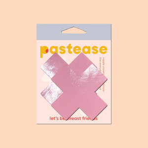 Plus X: Faux Latex Pleather Vinyl Baby Pink Cross Nipple Pasties by Pastease®. Two shiny pastel pink cross shaped nipple covers shown in the pastease packaging on a peach pink background.