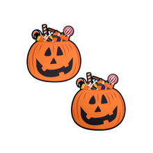 Load image into Gallery viewer, The Trick-or-Treat Pumpkin Pasties with Candy Nipple Covers by Pastease®. Two jack o lantern carved pumpkins stuffed full of various halloween candy nipple covers shown on a white background. Perfect for festivals, pride, burlesque, raves, only fans content or parties.
