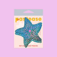 Load image into Gallery viewer, The Starfish: Twinkling Seafoam Green &amp; Pink Print Sea Star Nipple Pasties by Pastease®. Two aqua blue with holographic glitter and pink dots starfish shaped nipple covers shown in the pastease pastel packaging on a light purple background. Perfect for a festival, burlesque performance, pride or parties.
