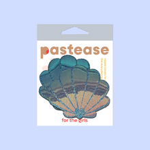 Load image into Gallery viewer, The Mermaid Shells Pasties in Opalescent Seafoam Blue Seashell Nipple Covers by Pastease®. Two blue green seafoam glitter with gold to pink iridescent film sea shells in the pastease pastel packaging on a pastel lilac background. Perfect for a festival, pride, burlesque performance, only fans content or a party.
