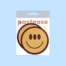 Load image into Gallery viewer, The Trippy Smiley Face Pasties Three Eyed Yellow Breast Covers by Pastease®. Two smiley faces with three eyes nipple covers shown in the pastease pastel packaging on a pastel blue background. Perfect for a festival, burlesque performance, pride or parties.
