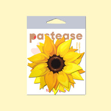 Load image into Gallery viewer, The Sunflower Pasties Nipple Covers by Pastease in the pastease cellophane packaging on a pastel yellow background. Two yellow sunflower shape nipple covers with brown middles and golden warm yellow petals surrounding. Perfect for burlesque shows, drag, content, pride, festivals and summer celebrations.
