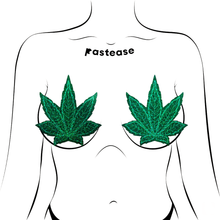 Load image into Gallery viewer, Coverage: Pot Leaf Glitter Green Full Breast Covers Support Tape by Pastease®. Two green glittery weed leaf shaped nipple covers shown on a femme body outline for size reference on a white background. Perfect for a festival, pride, burlesque performance, only fans content, 420 or a party.
